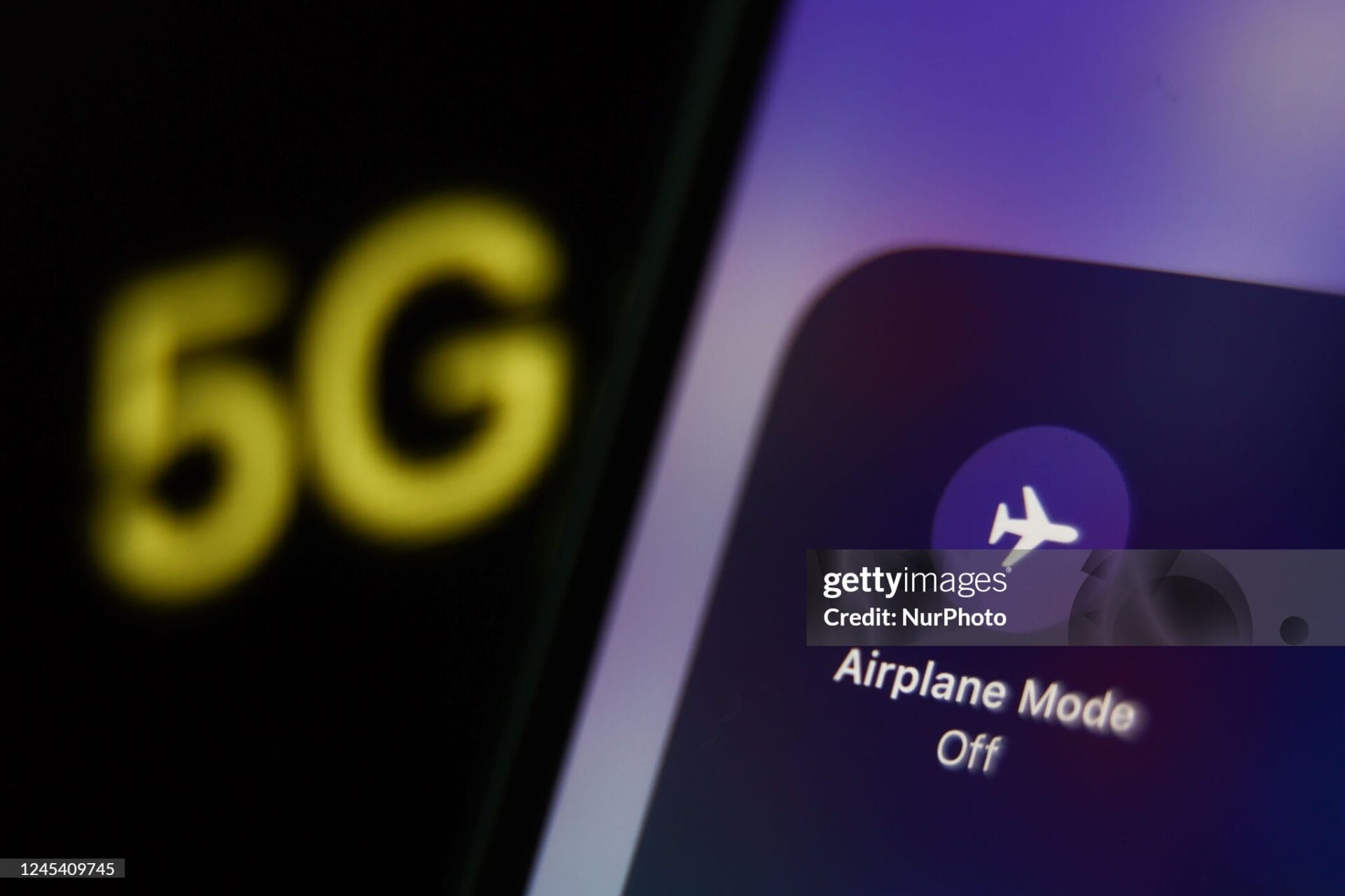 Airplane Mode icon displayed on a phone screen and 5G sign displayed on a screen are seen in this illustration photo taken in Krakow, Poland on December 6, 2022. (Photo by Jakub Porzycki/NurPhoto via Getty Images)