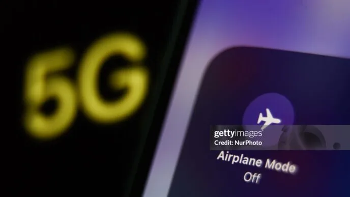 Airplane Mode icon displayed on a phone screen and 5G sign displayed on a screen are seen in this illustration photo taken in Krakow, Poland on December 6, 2022. (Photo by Jakub Porzycki/NurPhoto via Getty Images)