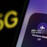 Airplane Mode icon displayed on a phone screen and 5G sign displayed on a screen are seen in this illustration photo taken in Krakow, Poland on December 6, 2022. (Photo by Jakub Porzycki/NurPhoto via Getty Images)